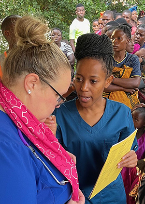 Peds triage nurse Joy collaborating with Tanzanian translator